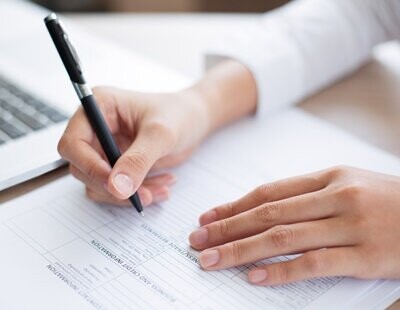 closeup-of-business-person-completing-form